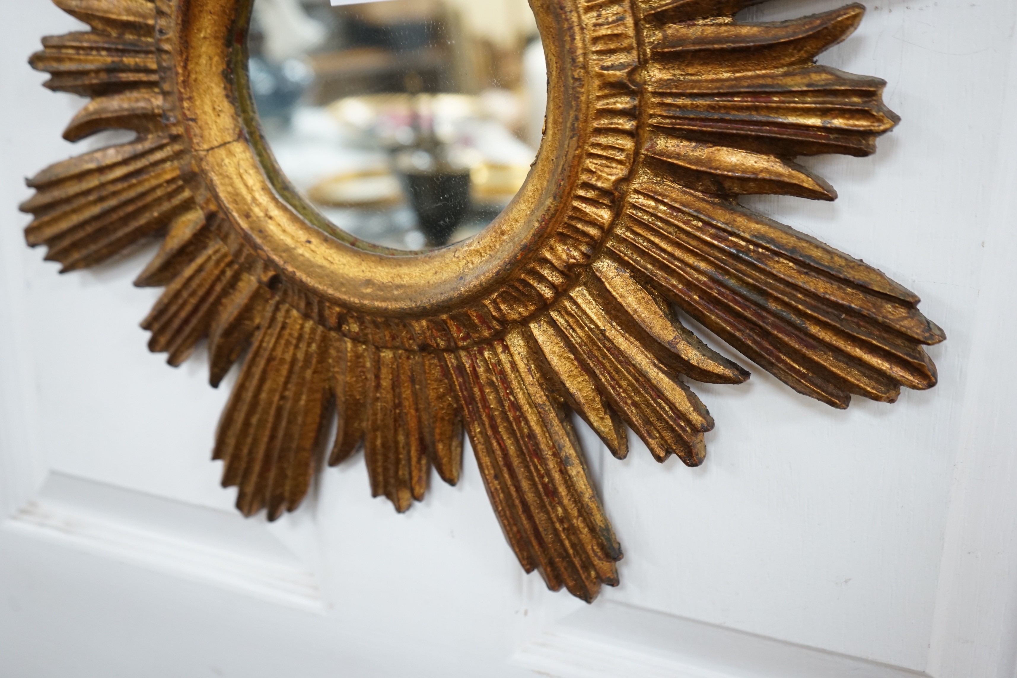 A gilt star-burst wall mirror, 47cm